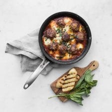 Spicy meatballs with golden baked mozzarella and parmesan cheese
