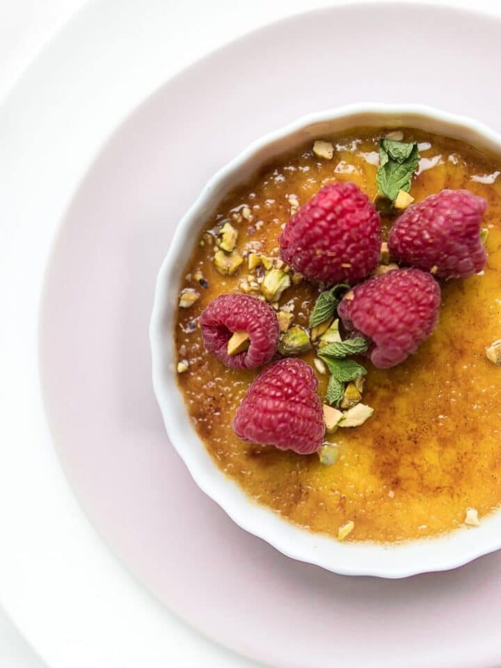 Close up of coconut creme brulee on a pink plate