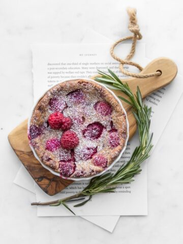 Small raspberry clafoutis on a small wooden board