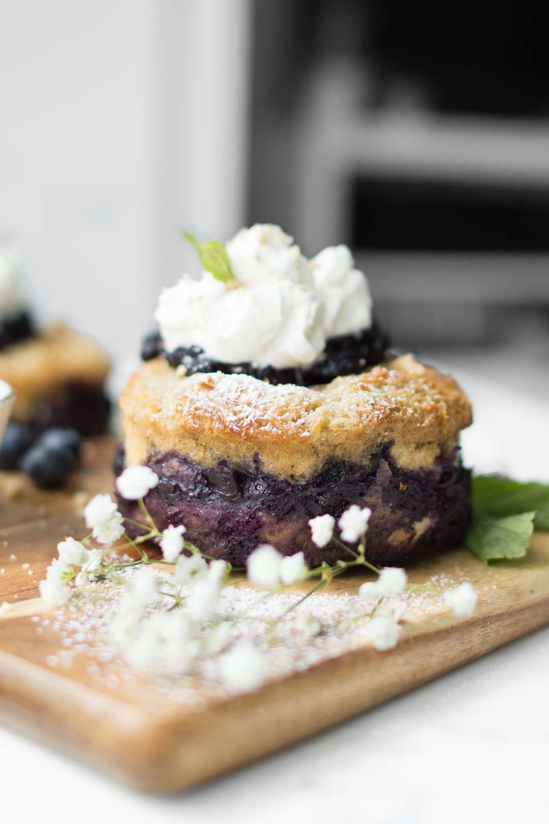 Blueberry French Toast Cake on a wooden board with baby's breath