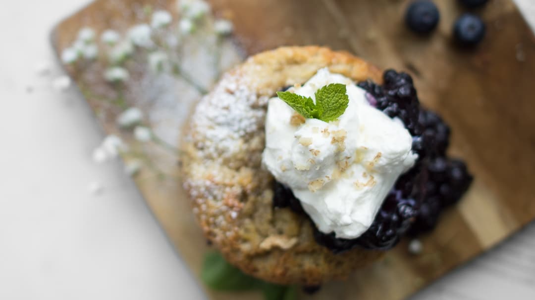 Overhead closeup of Blueberry French Toast Cake with whipped cream and blueberry sauce