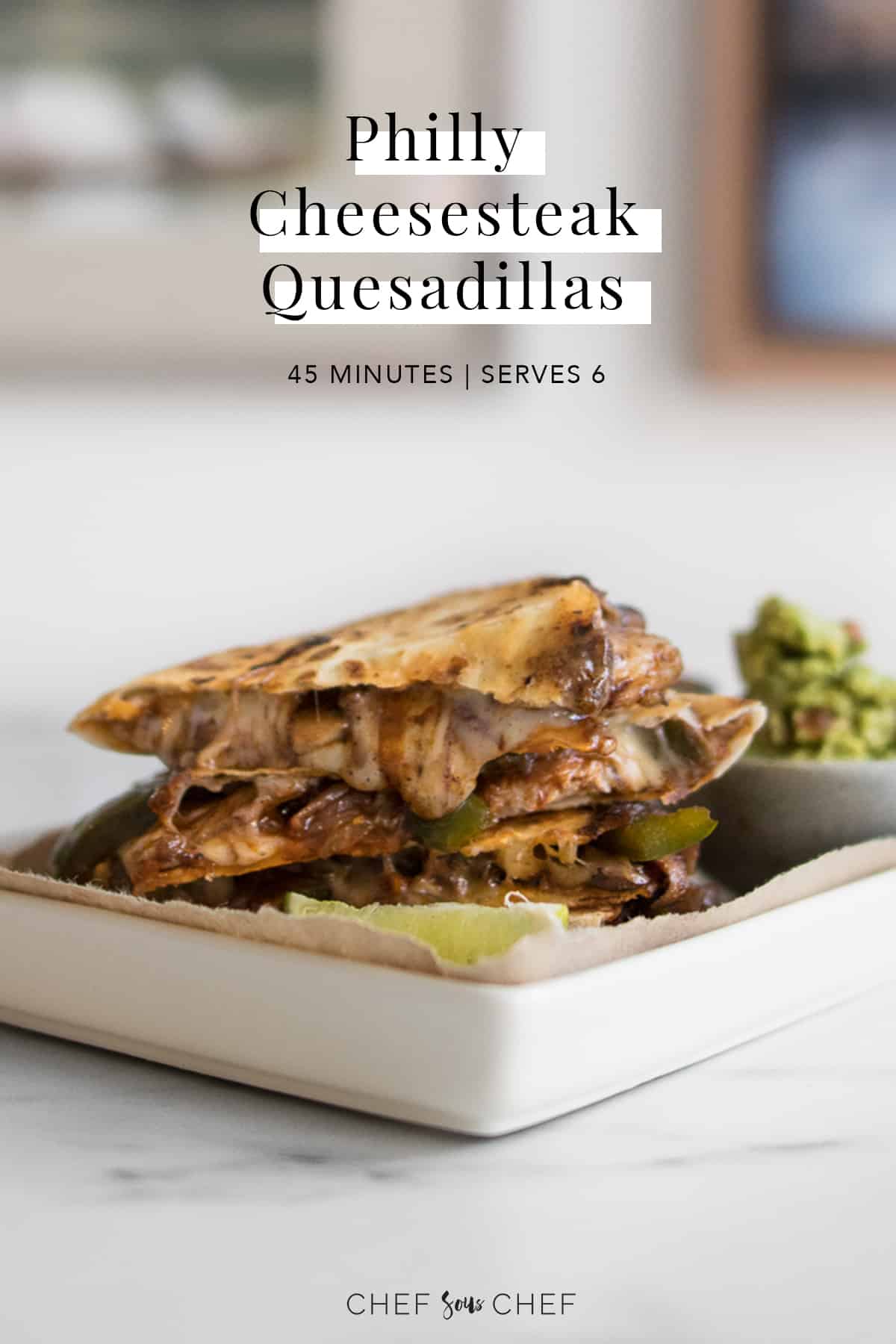 Philly Cheesesteak Quesadillas on a plate with guacamole and text overlay