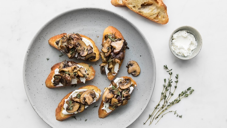 Mushroom Toast on a grey plate with goat cheese and thyme