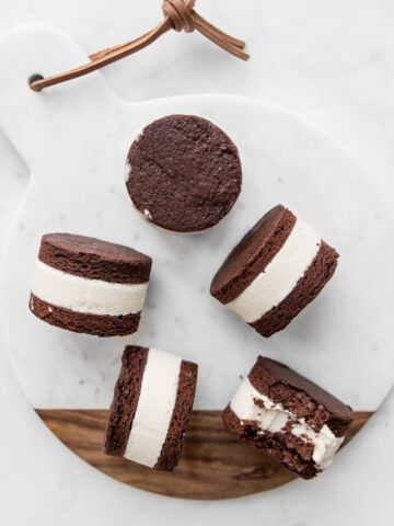 Coconut Ice Cream Sandwiches on a marble and wooden board