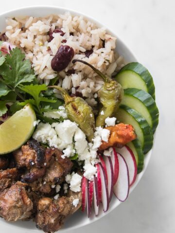 Close up of BBQ Jerk Chicken Bowl with Rice and Peas + Pineapple Coleslaw