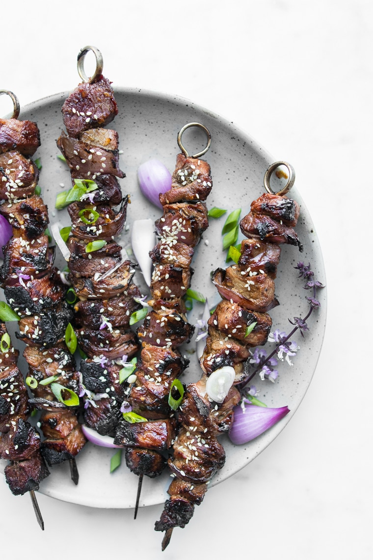 Close up of Sweet and Sour BBQ Beef Kebabs garnished with Green Onions and Sesame Seeds