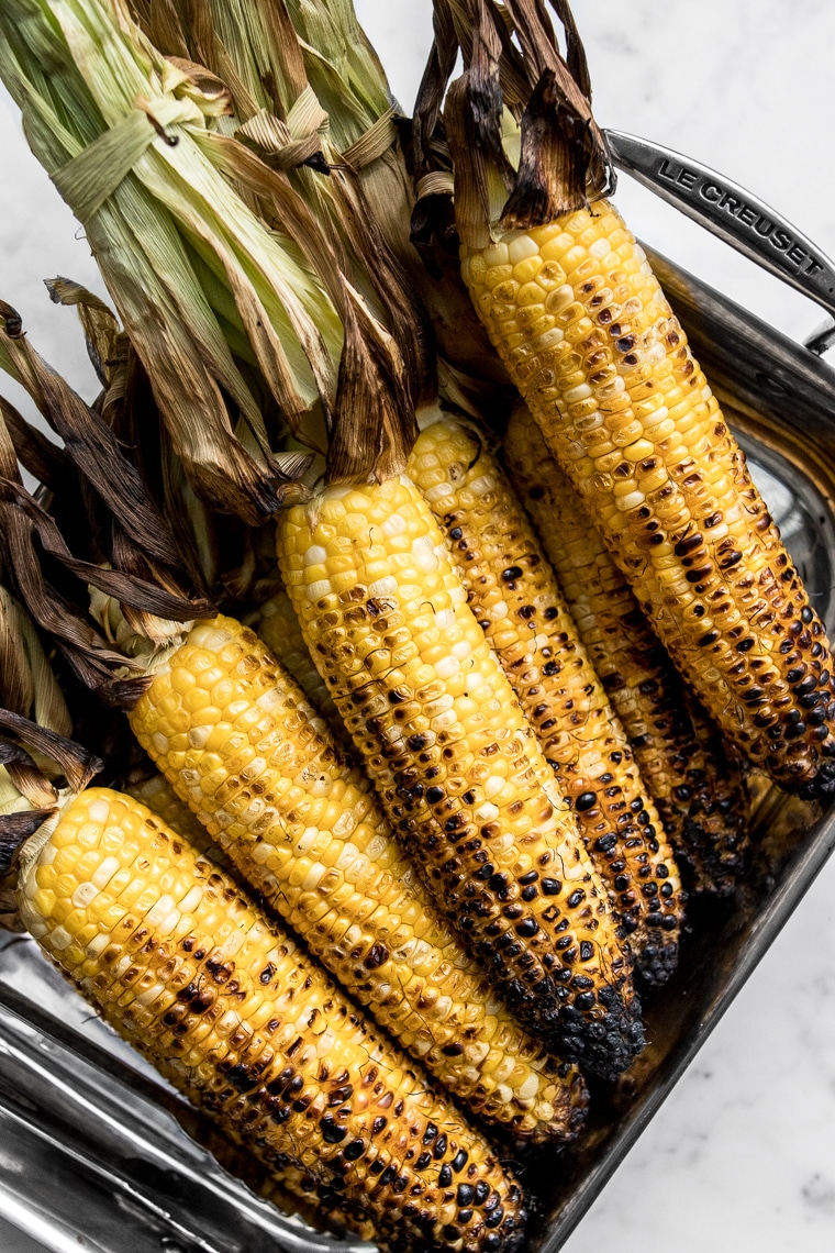 Grilled corn with husks peeled back