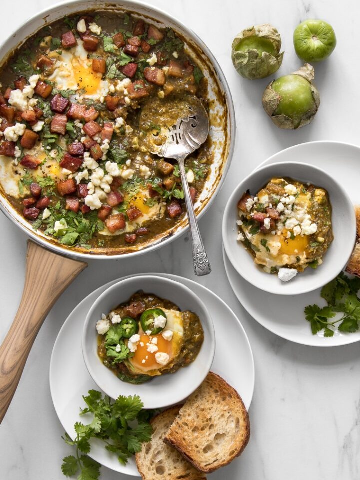 Green Shakshuka Recipe with Bacon and Tomatillo Sauce - Served as an early meal, brunch or a weeknight dinner, it’s a one-skillet dish that’s filled with bright and spicy notes and is as effortless as it is delicious, and our take on it is the perfect blend of a Middle-Eastern and Mexican flair. #brunch #breakfast #comfortfood #foodphotography #foodstyling