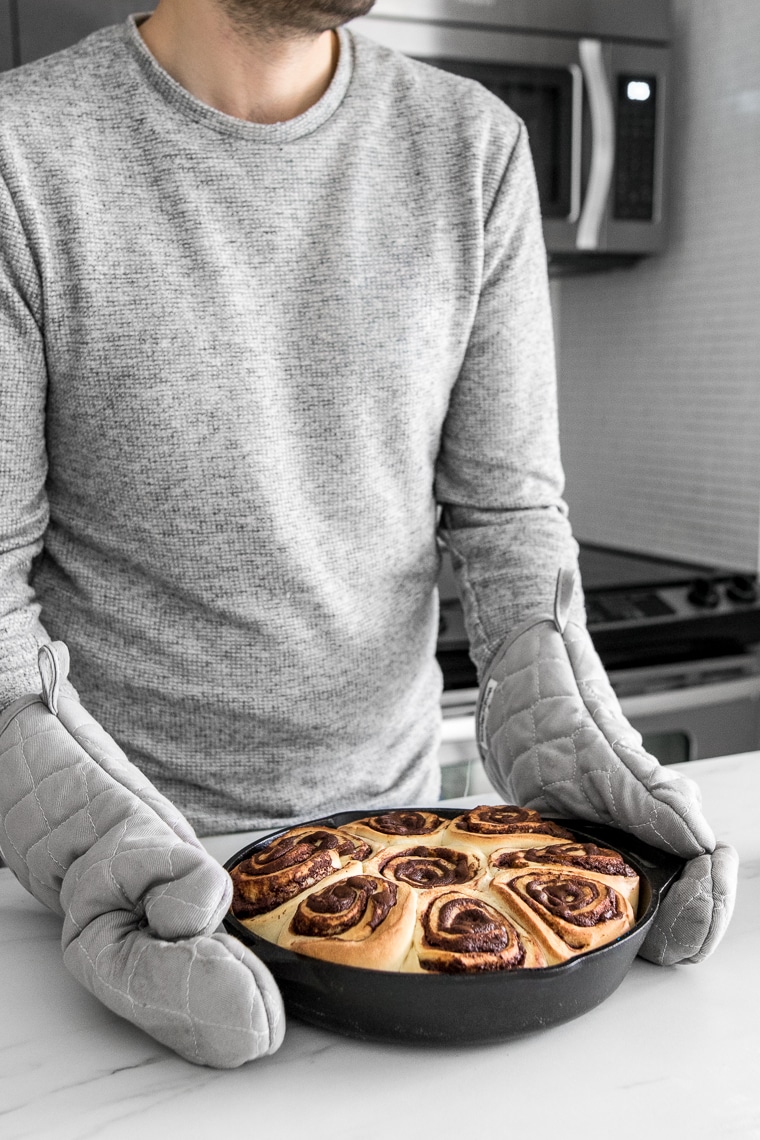 Holding the skillet with the freshly baked chocolate rolls