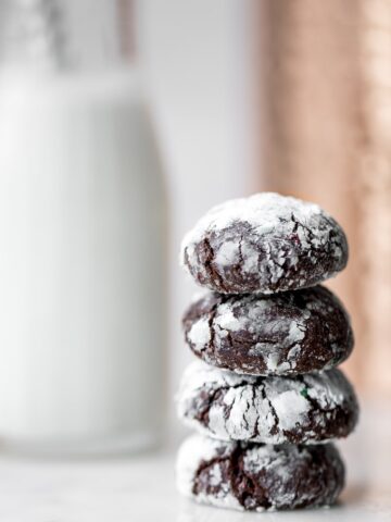 Stack of four Double Chocolate Crinkle Cookies with Candy Cane
