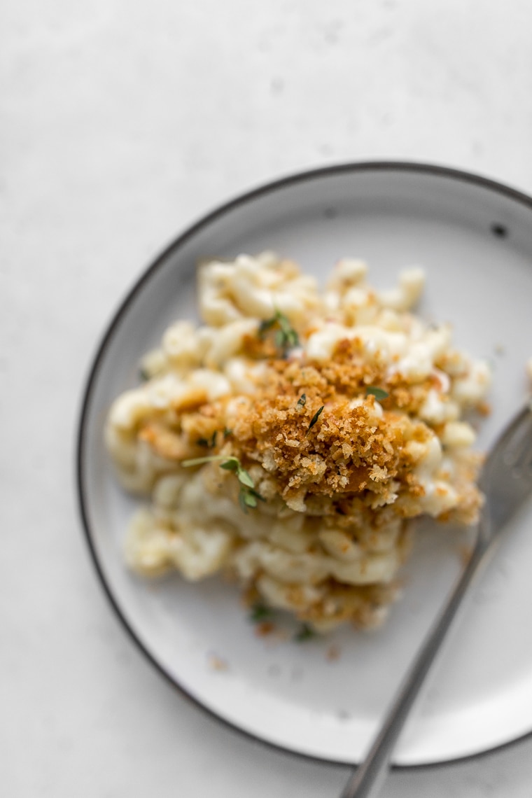 Close up of Goat Cheese Mac and Cheese on a plate topped with bread crumbs