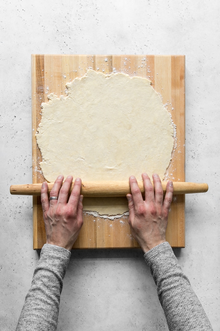 Rolling dough on a wooden cutting board