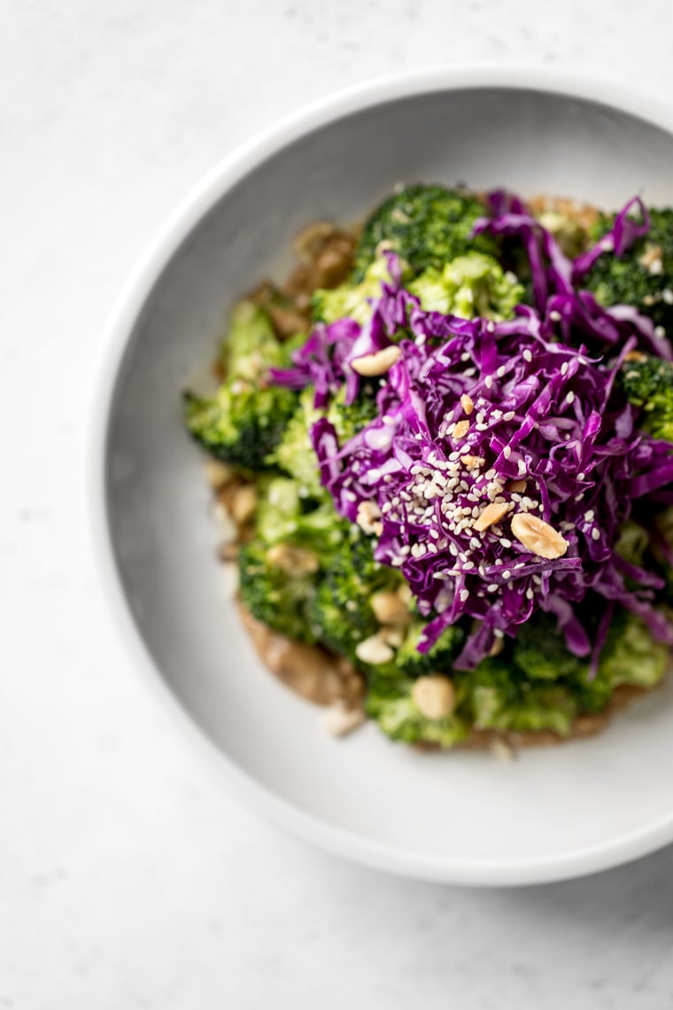 Overhead photo of broccoli salad with red cabbage on top