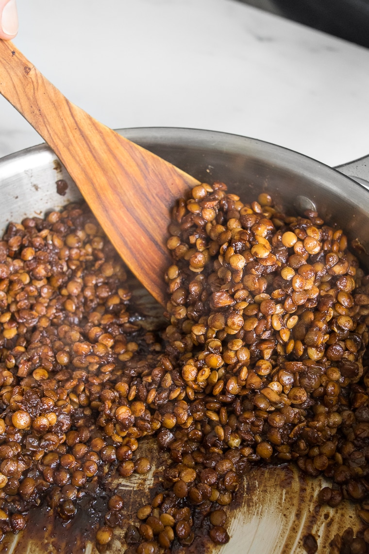 Close up of seasoned lentils cooking in a skillet