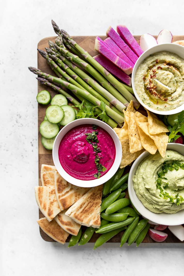 Close Up of White Bean and Beet Hummus with Vegetables and Pita Chips