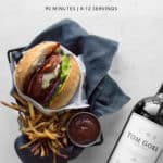 Burger, red wine, fries, and ketchup with recipe text