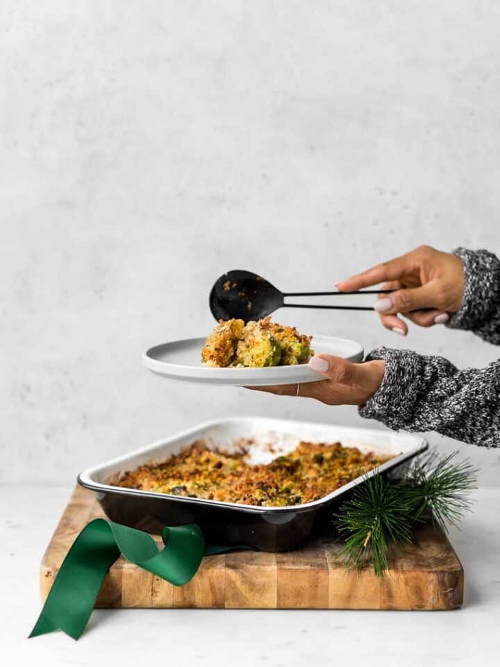 Gratin on a cutting board being served on a plate.