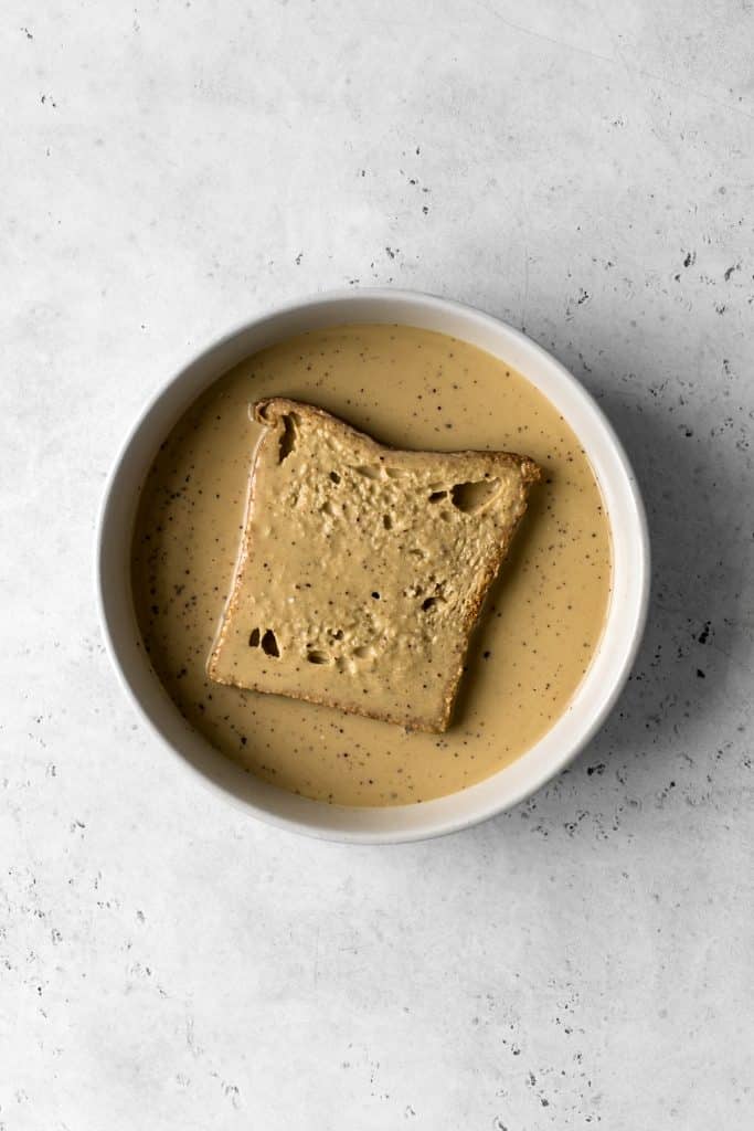 Bread soaking in french toast egg batter