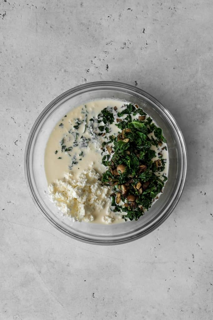 Cream, kale and mushrooms in a bowl