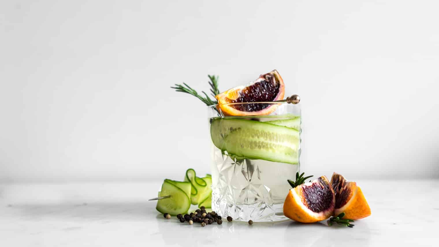 Gin and Tonic in a crystal glass with cucumber, blood orange and rosemary