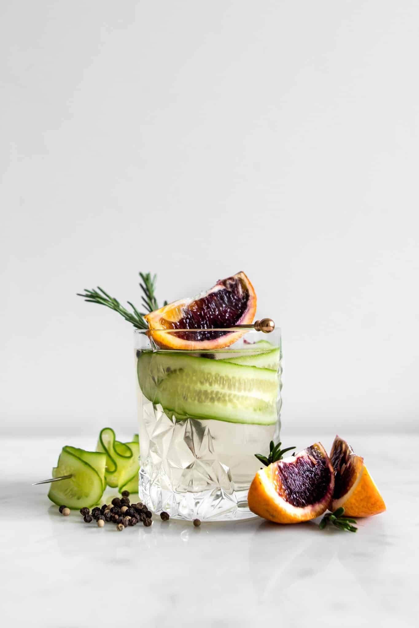 Gin and Tonic in a Crystal Glass with Cucumber, Blood Orange Wedges and Rosemary
