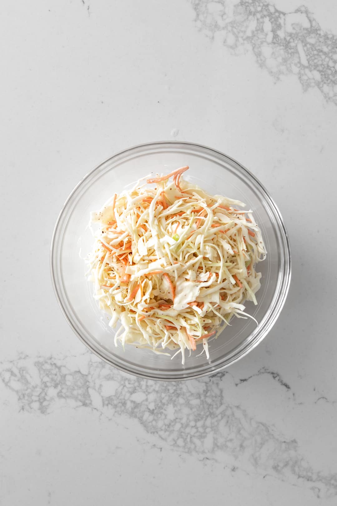 Clear bowl of creamy coleslaw