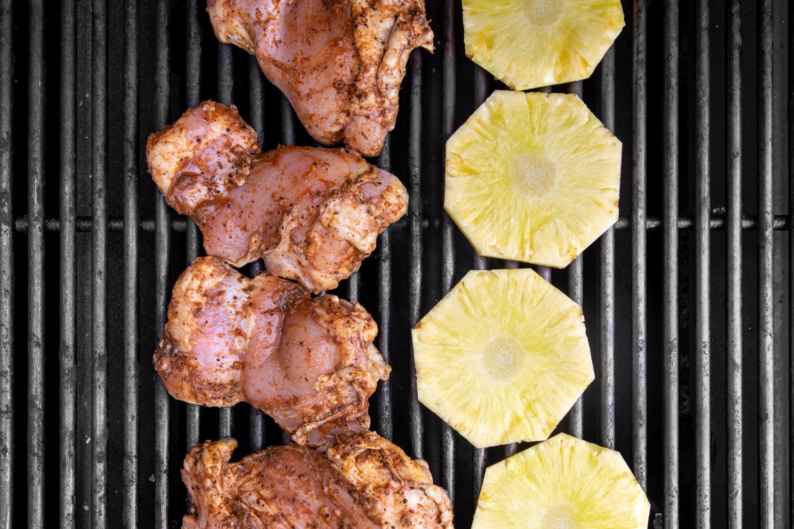 jerk marinated chicken and pineapple slices on a bbq