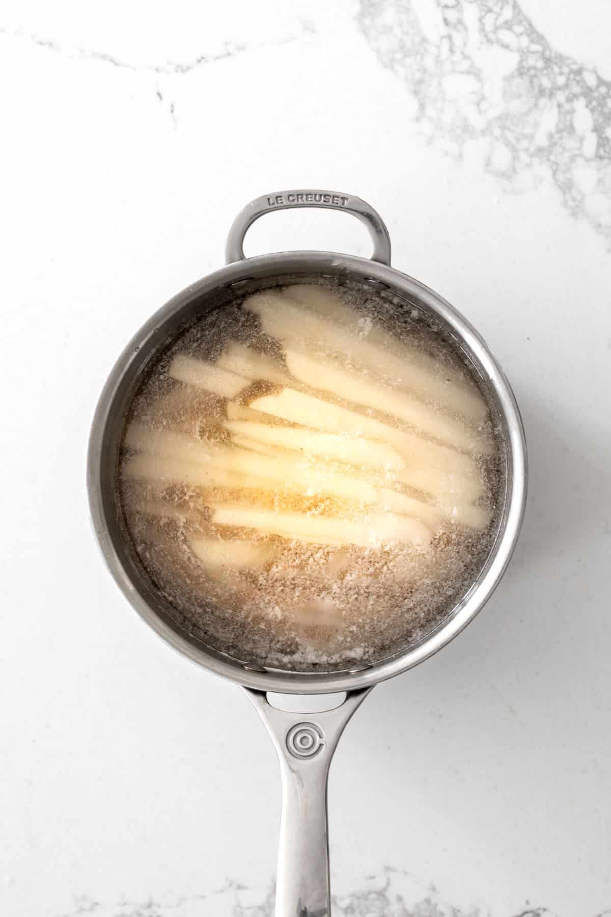Potato fries in a pot of water