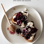 Ricotta Toast with Cherries on a Plate with a honey stick