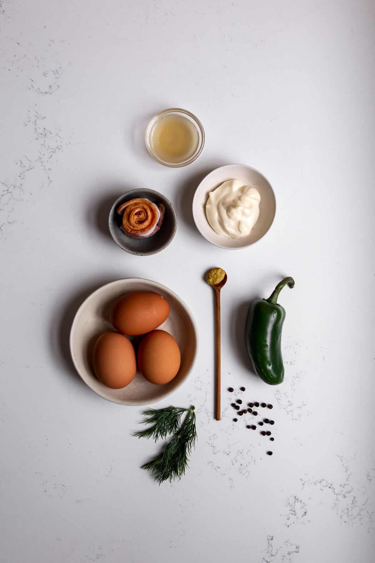 Ingredients needed to make a spicy deviled egg with jalapeno.