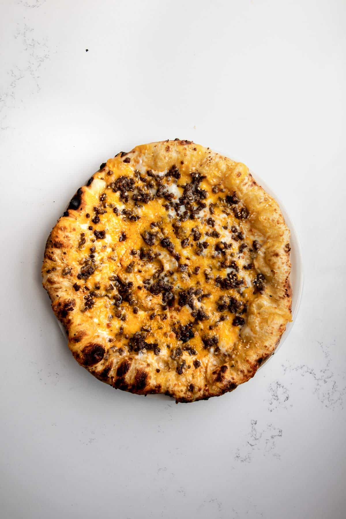 Neapolitan-style Big Mac pizza cooked with melted cheddar and mozzarella cheese and ground beef.