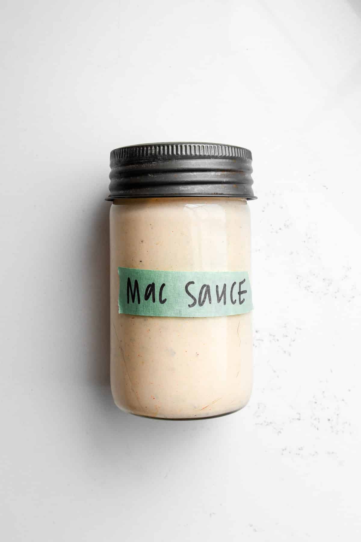 A mason jar filled with big mac sauce with a green label that reads mac sauce.
