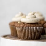 Carrot Cake Muffins arranged on a platter and topped with brown butter frosting.