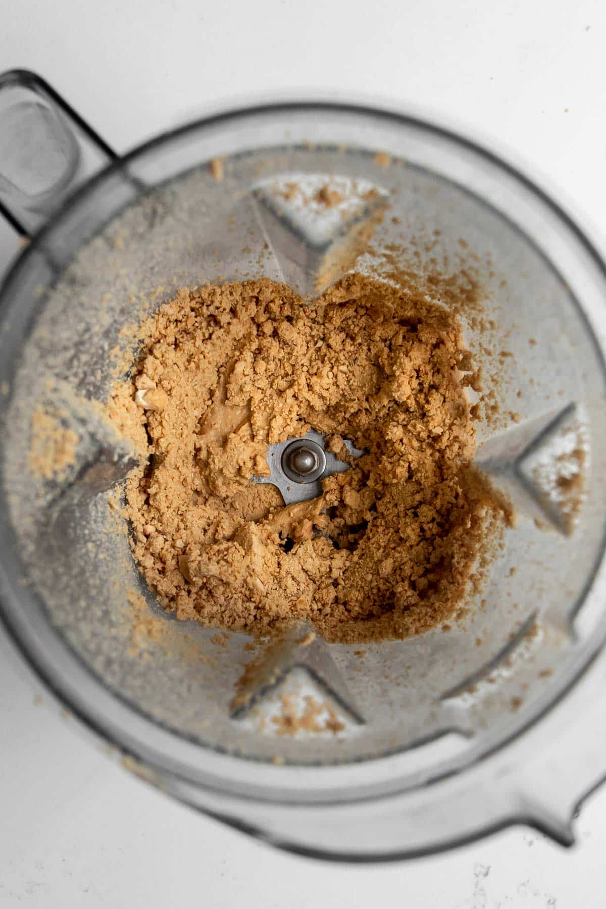Cashew paste or crumble in a Vitamix container.