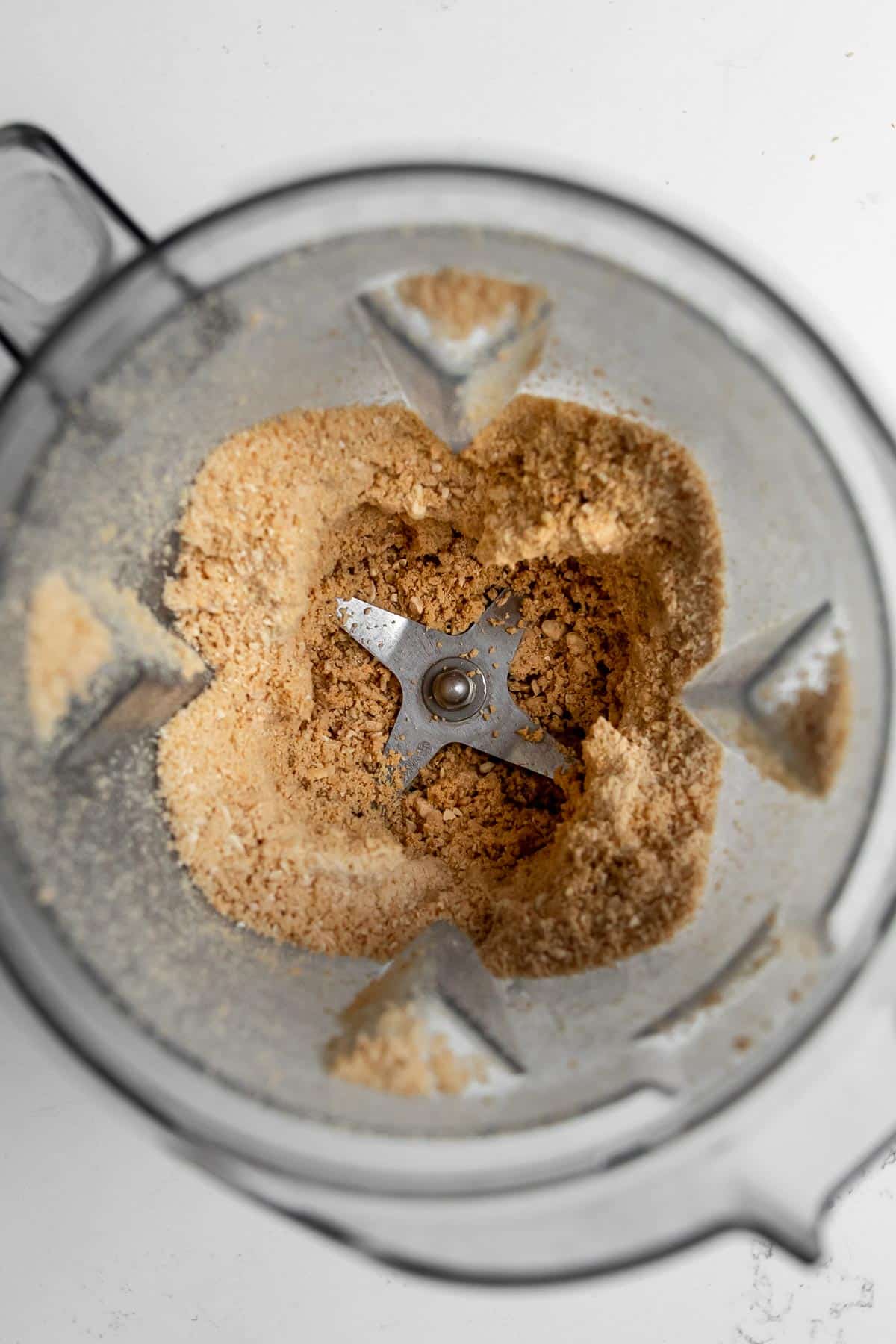 Overhead view of cashew powder in a blender container.