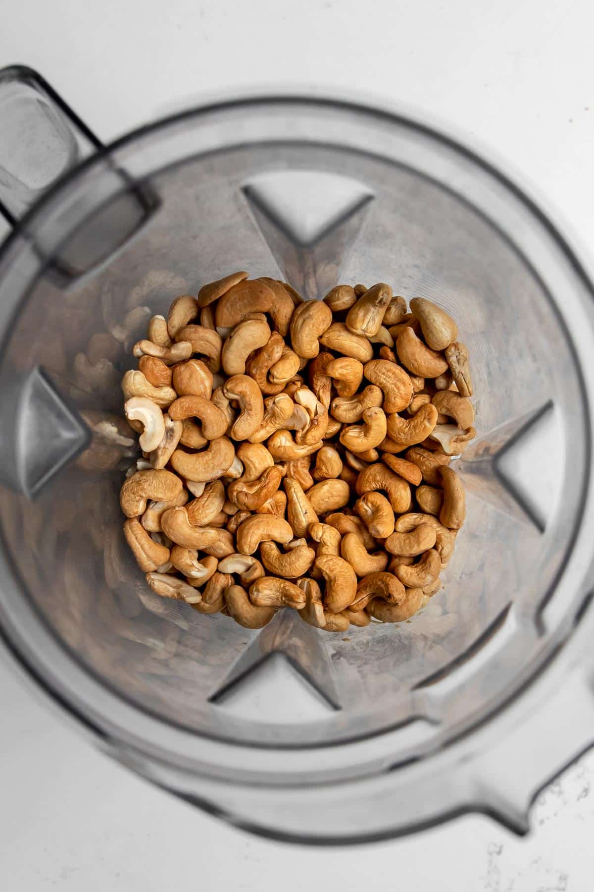 Overhead view of roasted cashews in a Vitamix container.