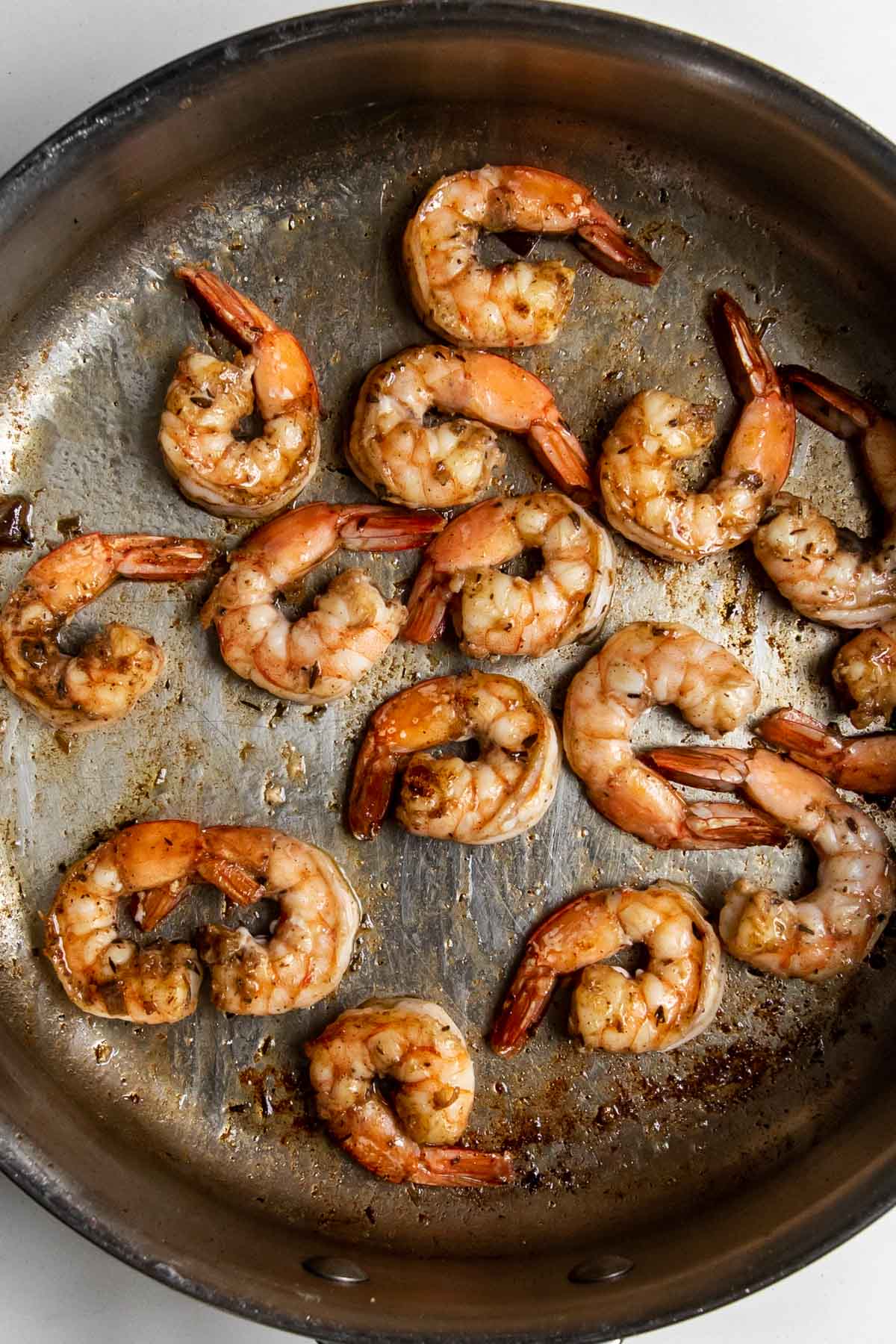 cooked jerk marinated shrimp in a sauté pan.