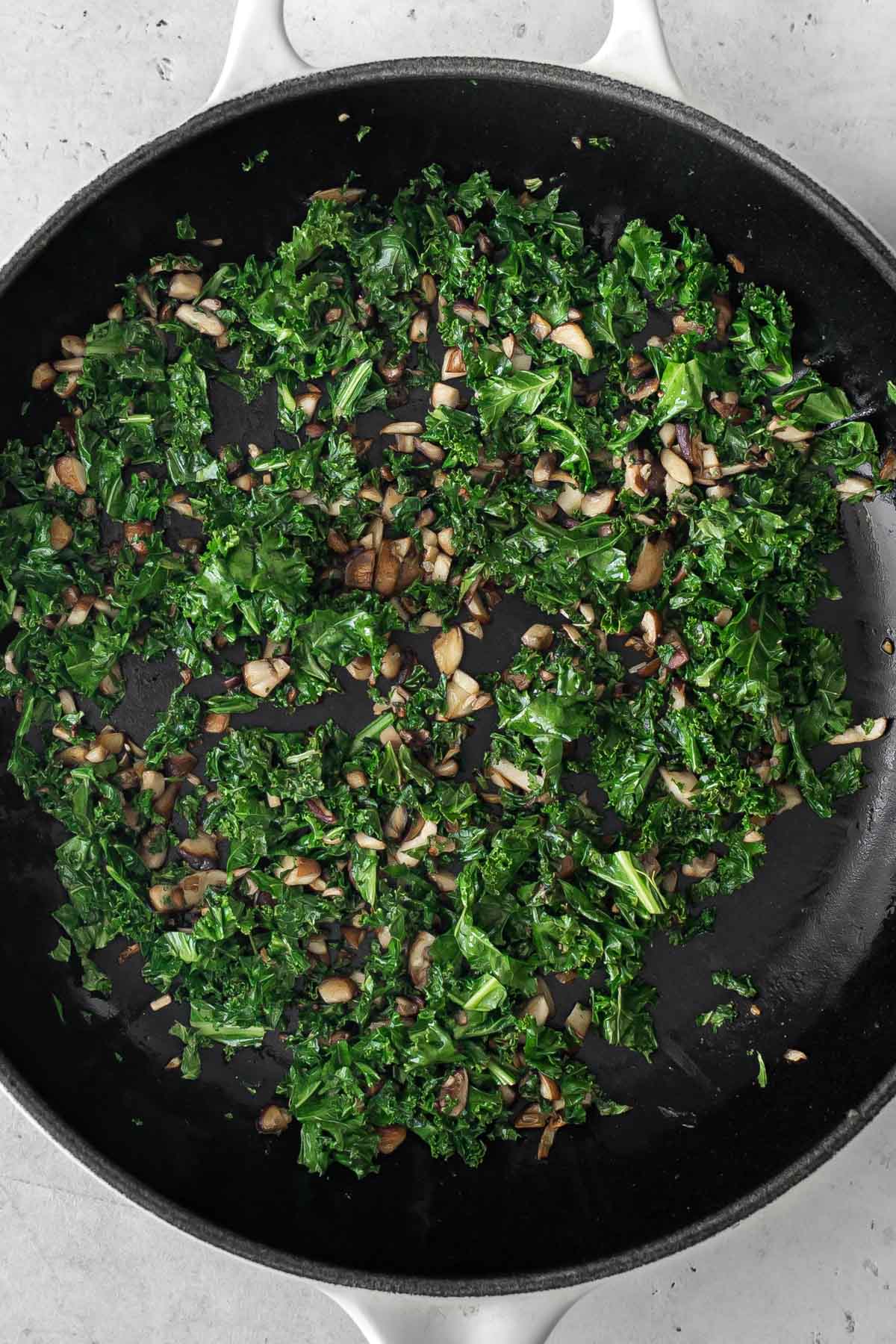 cooked mushroom and kale in a skillet.