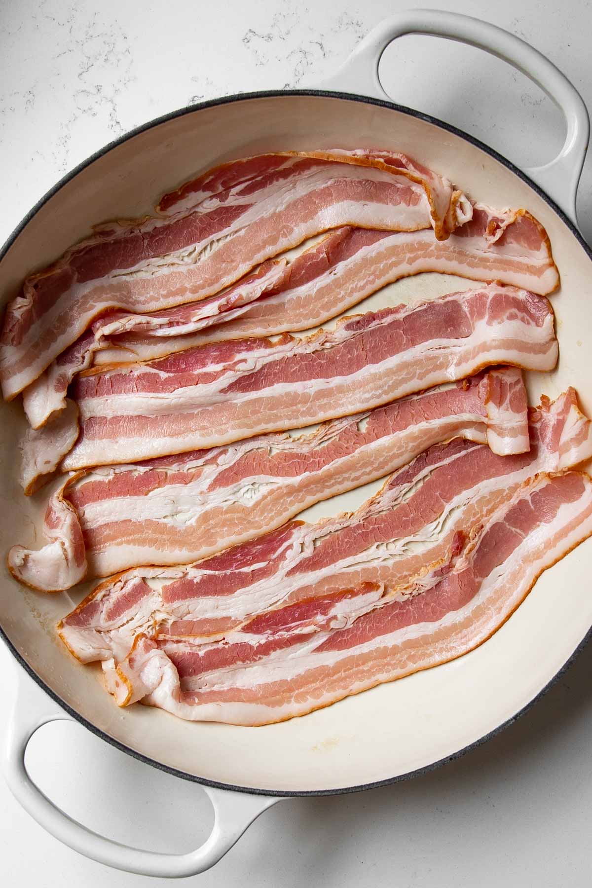 uncooked bacon in a cold skillet.