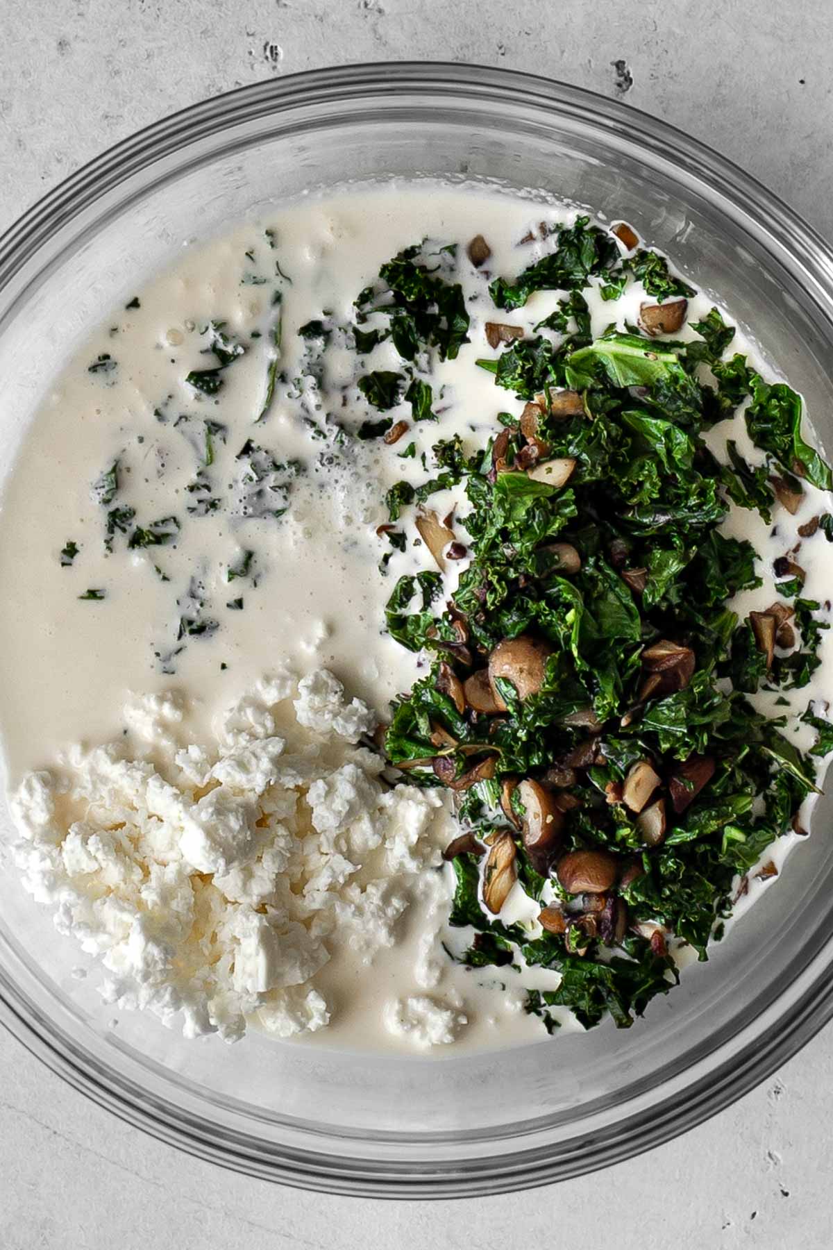 bowl of cream, cooked mushroom and kale and feta.