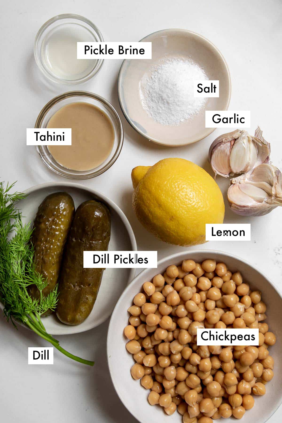 ingredients to make dill pickle hummus arranged on table.