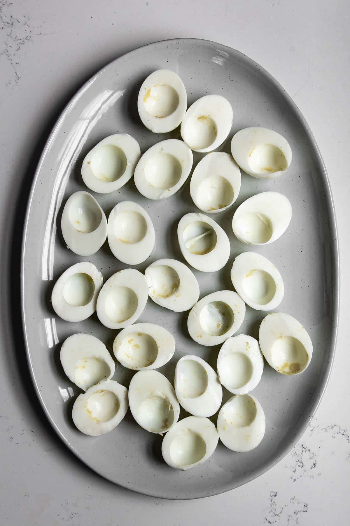 emptied hard boiled egg whites on a large platter.