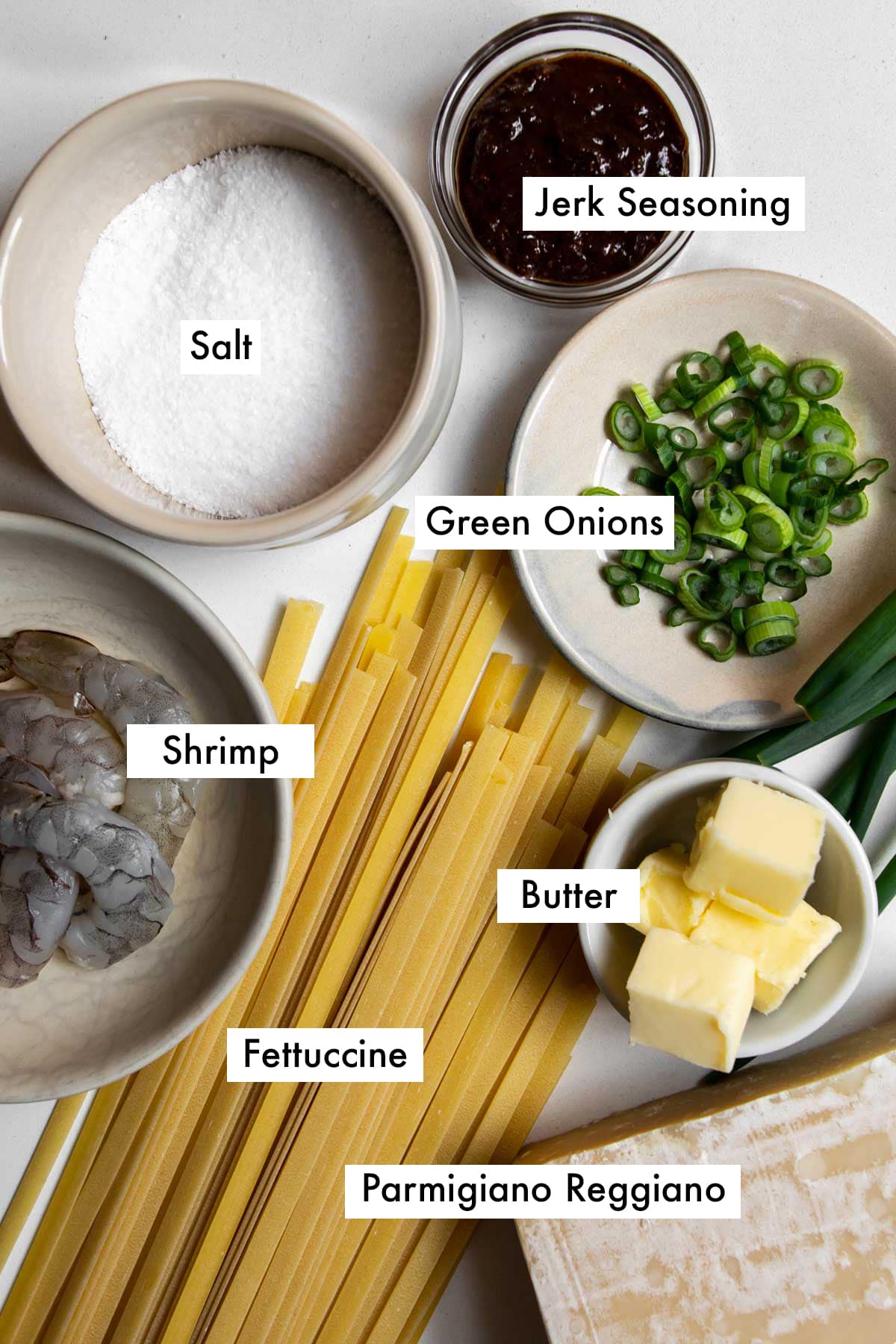 ingredients to make jerk shrimp pasta on a table.