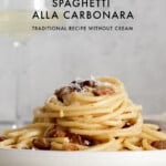 carbonara spaghetti on a plate with a glass of wine and text graphic.