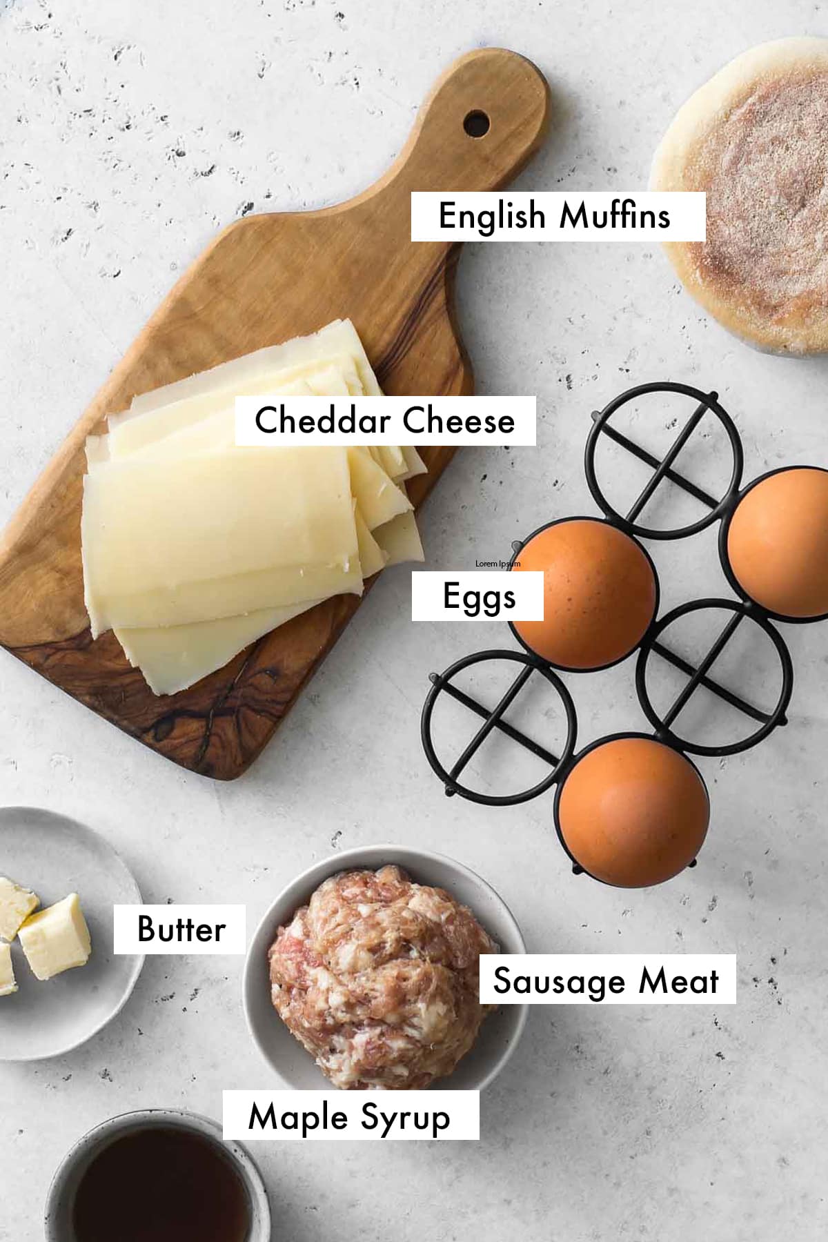 ingredients for sausage, egg and cheese mcmuffin breakfast sandwich with labelled text.