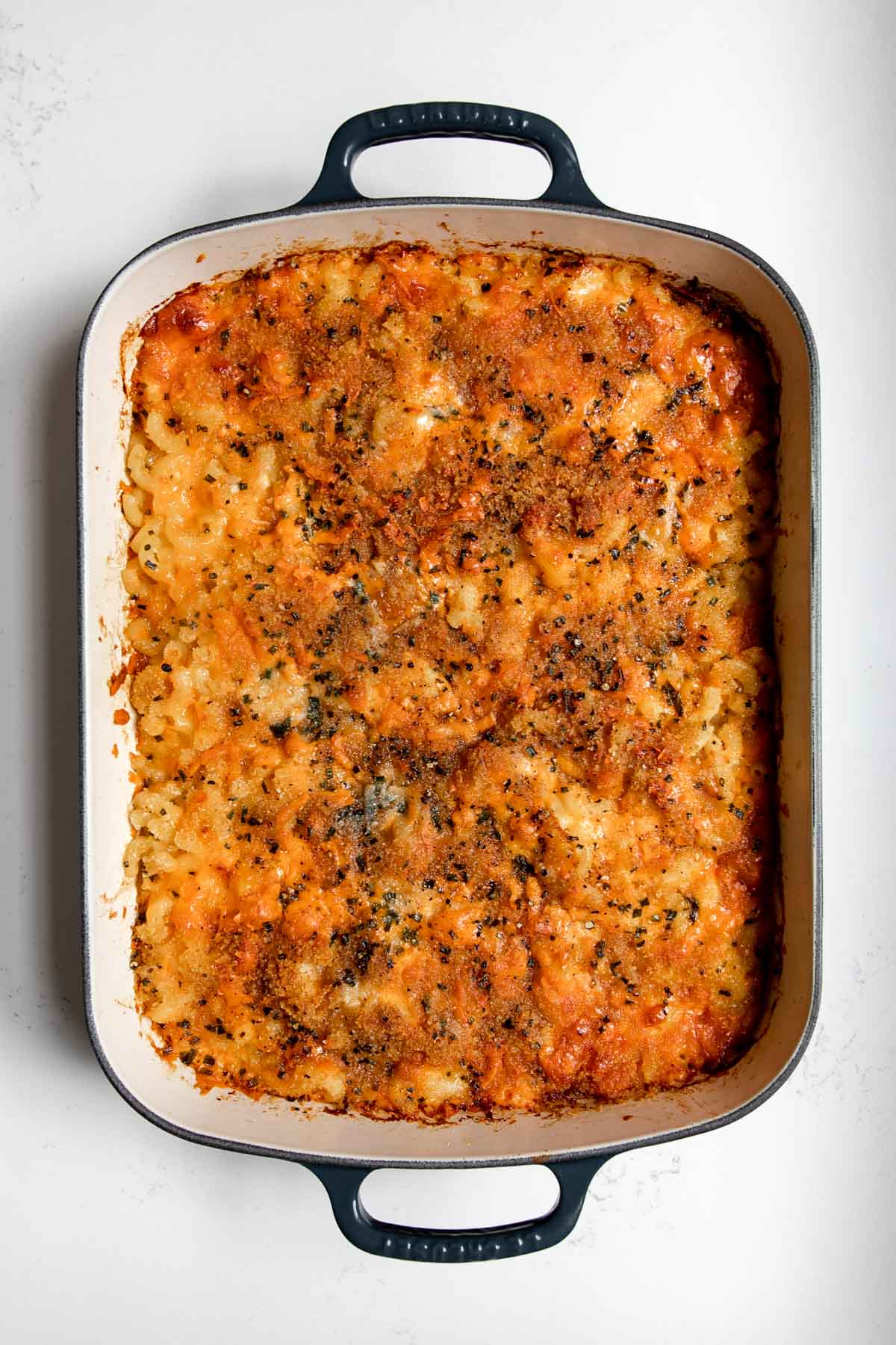 old fashioned baked macaroni and cheese in a cast-iron pan.