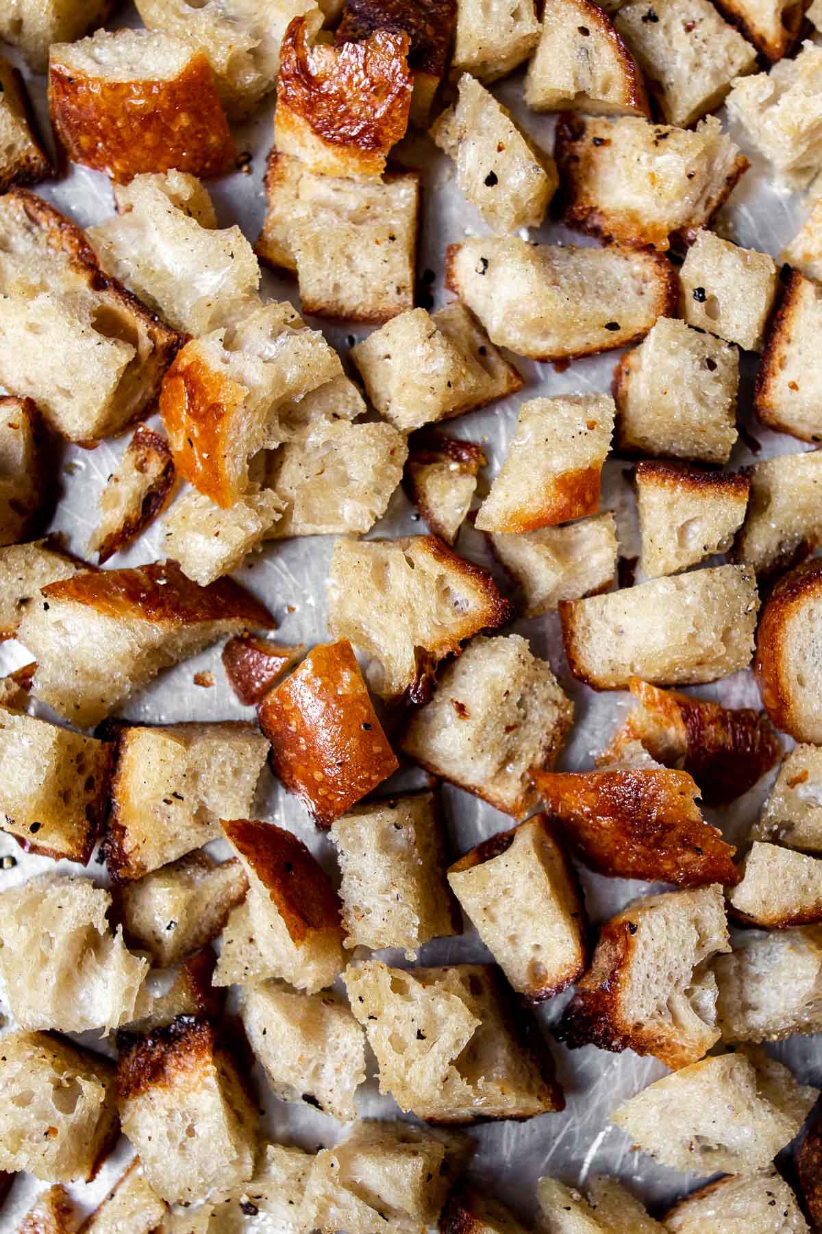 Baked sourdough croutons on a sheetpan.