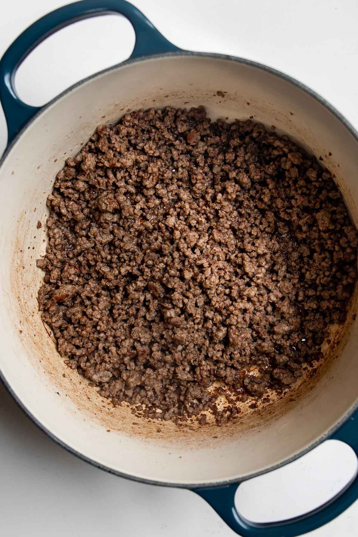 browned ground beef cooking in a pot.