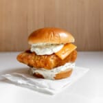 fried cod fish sandwich (homemade filet-o-fish) on a table.