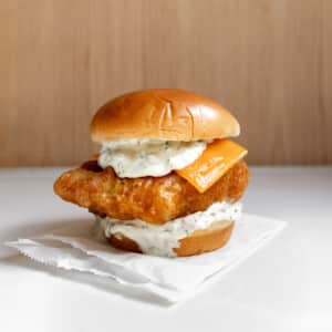 fried cod fish sandwich (homemade filet-o-fish) on a table.